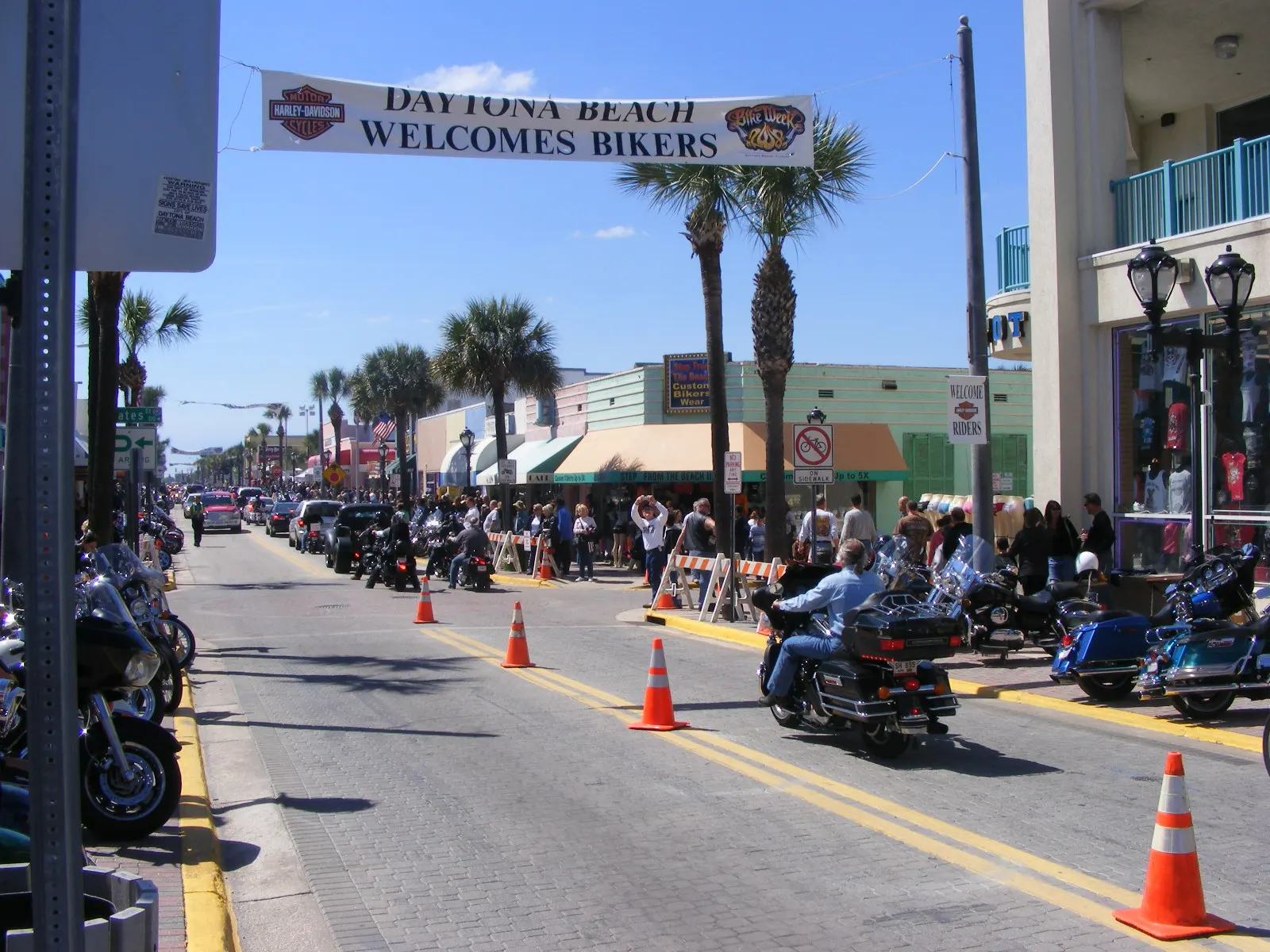 A "Daytona Beach Welcomes Bikers" banner hangs over Main Street in Daytona Beach during Bike Week.