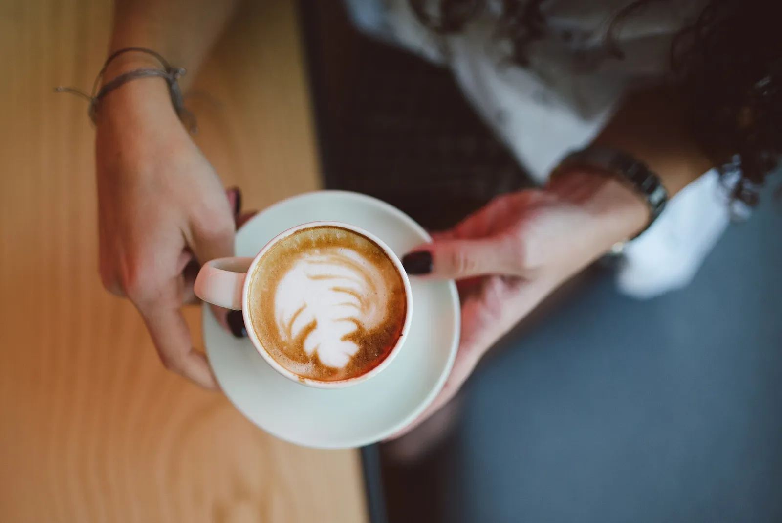 A cappuccino with latte art on a cafe table. The photo was not taken in Daytona Beach.