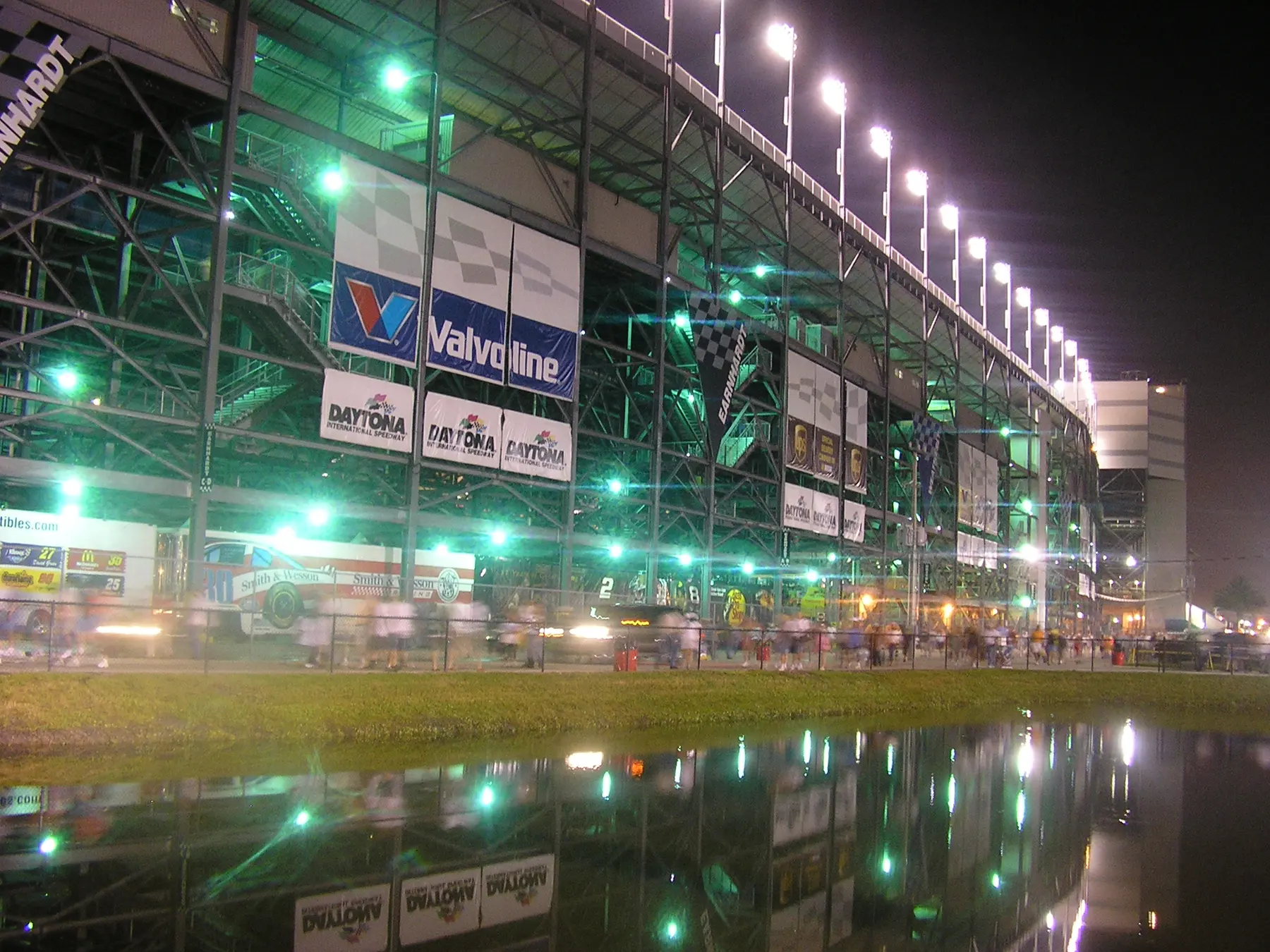 The main entrance of Daytona International Speedway lit up at night; Magic of Lights runs at the speedway each holiday season.