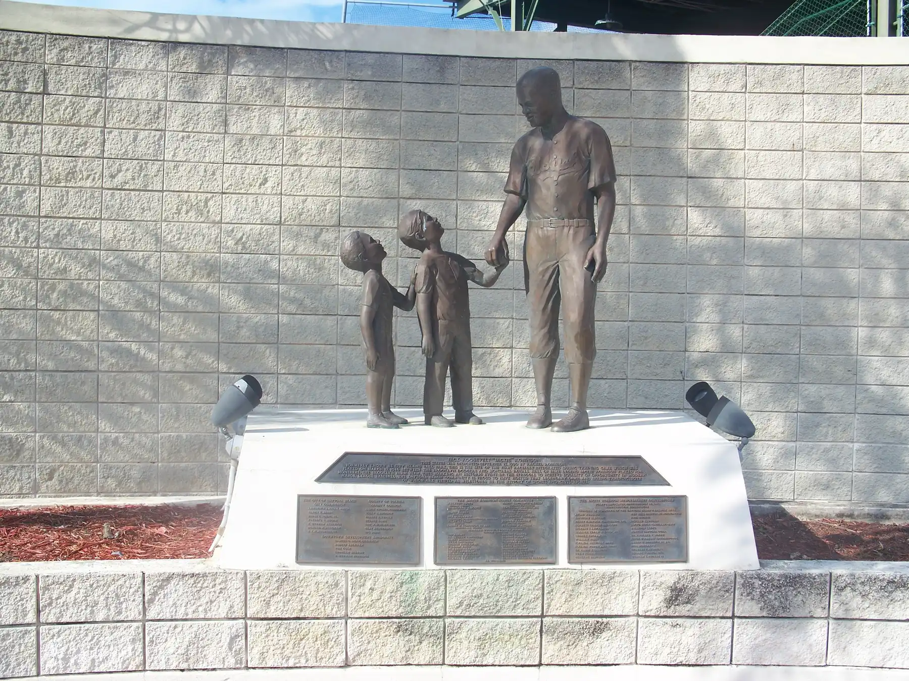 The statue of Jackie Robinson with two young fans outside Jackie Robinson Ballpark on City Island.